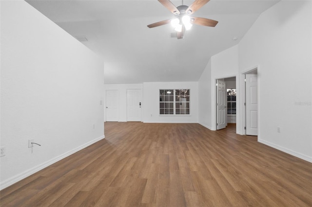 unfurnished living room with hardwood / wood-style floors, ceiling fan, and high vaulted ceiling