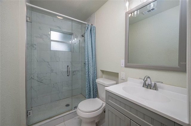 bathroom featuring a shower with shower door, toilet, vanity, and tile patterned flooring