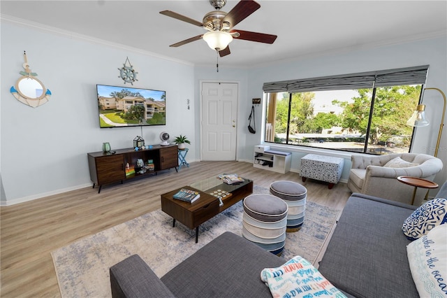 living room with crown molding, wood-type flooring, and ceiling fan