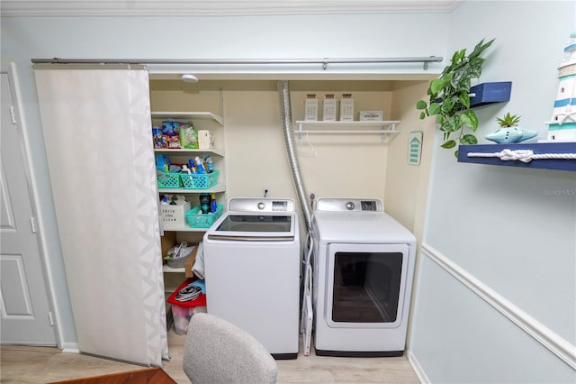 washroom featuring washer and clothes dryer and light wood-type flooring