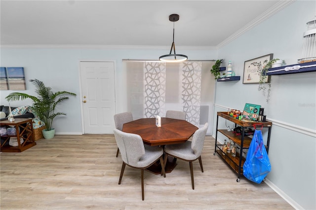 dining room featuring crown molding and light wood-type flooring