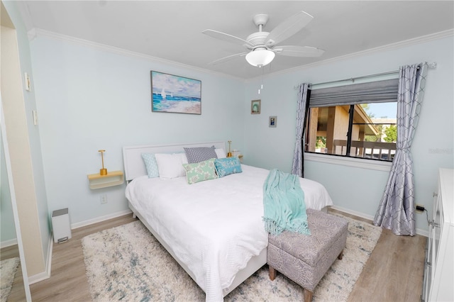 bedroom with ornamental molding, ceiling fan, and light wood-type flooring