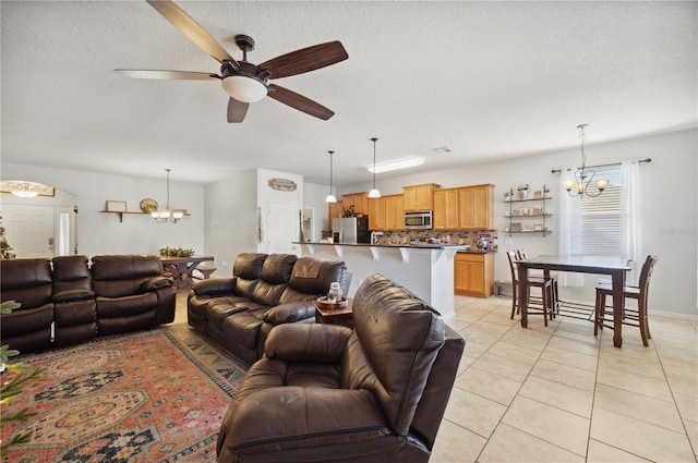 1849 Charleston Ln, Bartow, FL 33830 - living room with a chandelier, light tile patterned floors, a ceiling fan, and a textured ceiling