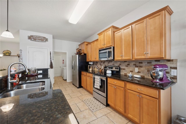 1849 Charleston Ln, Bartow, FL 33830 - kitchen featuring appliances with stainless steel finishes, a sink, tasteful backsplash, and dark stone countertops