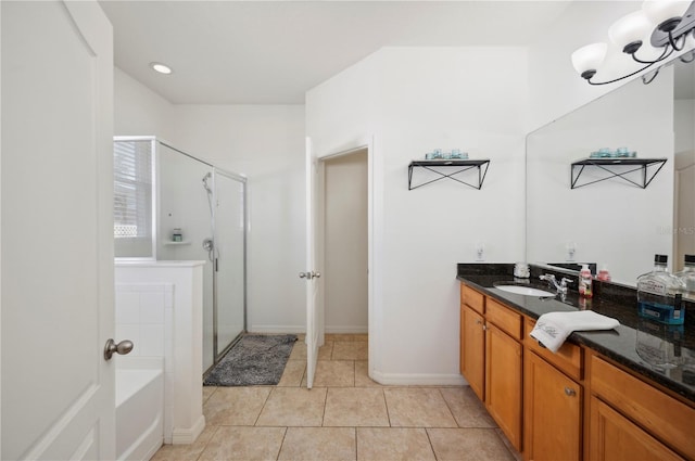 1849 Charleston Ln, Bartow, FL 33830 - bathroom featuring a stall shower, vanity, tile patterned flooring, a bath, and baseboards