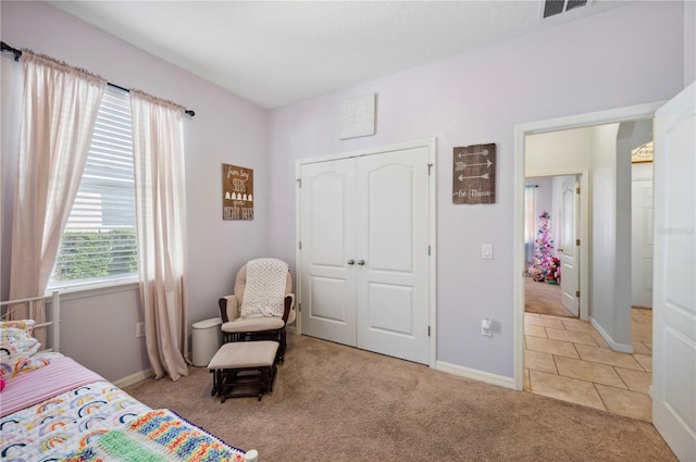 1849 Charleston Ln, Bartow, FL 33830 - bedroom featuring carpet floors, baseboards, a closet, and tile patterned flooring