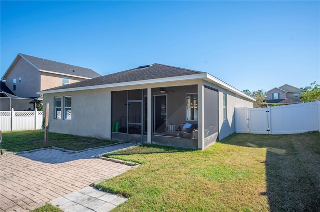 1849 Charleston Ln, Bartow, FL 33830 - rear view of house featuring a sunroom, a gate, stucco siding, ceiling fan, and a patio area
