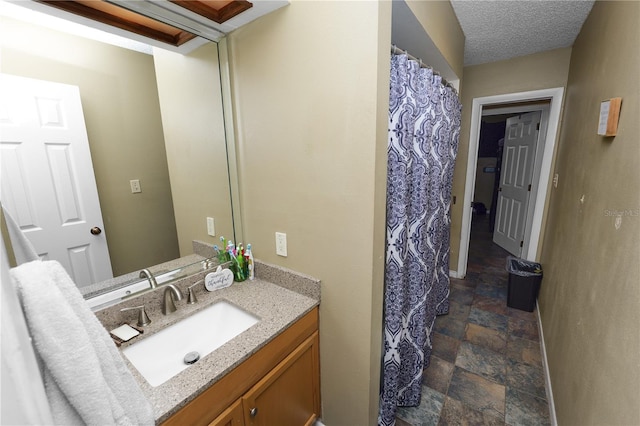 bathroom with vanity and a textured ceiling