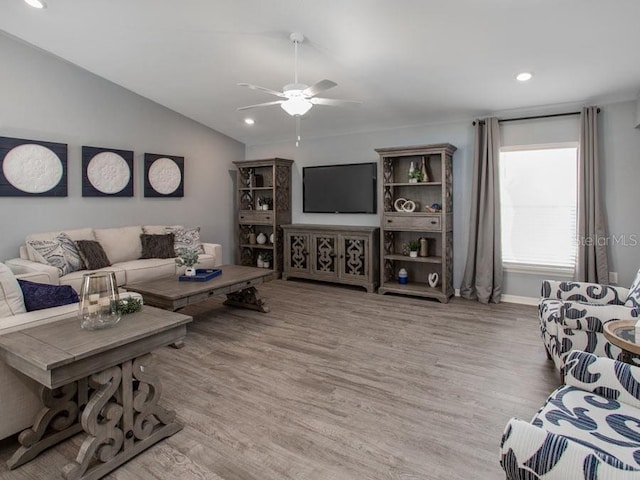 living room with lofted ceiling, wood-type flooring, and ceiling fan