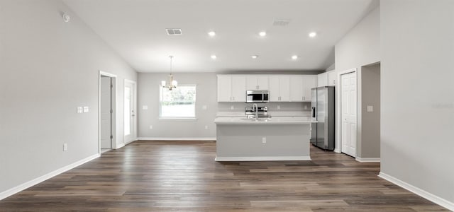 572 SW 77th Cir, Ocala, FL 34480 - kitchen featuring appliances with stainless steel finishes, vaulted ceiling, a chandelier, an island with sink, and white cabinetry