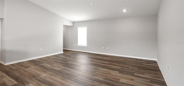 572 SW 77th Cir, Ocala, FL 34480 - spare room featuring baseboards, dark wood finished floors, lofted ceiling, and recessed lighting