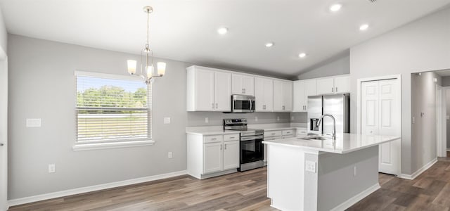 572 SW 77th Cir, Ocala, FL 34480 - kitchen with appliances with stainless steel finishes, a sink, wood finished floors, light countertops, and vaulted ceiling