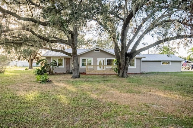 rear view of property featuring a lawn