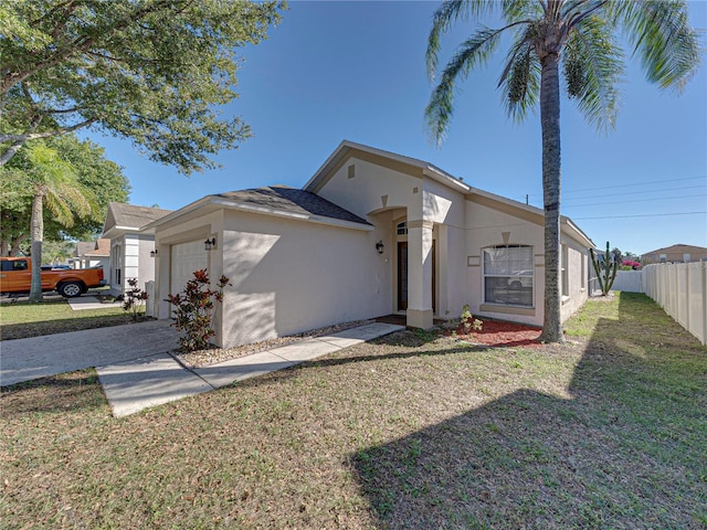 rear view of house with a yard and a garage