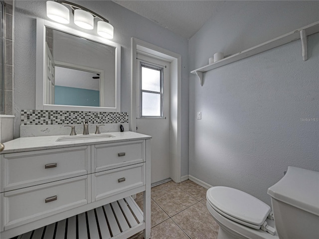 bathroom with tile patterned flooring, backsplash, a textured ceiling, toilet, and vanity