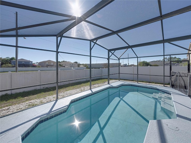 view of swimming pool with a lanai