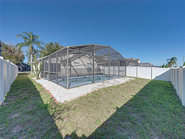 view of yard with a lanai and a fenced in pool