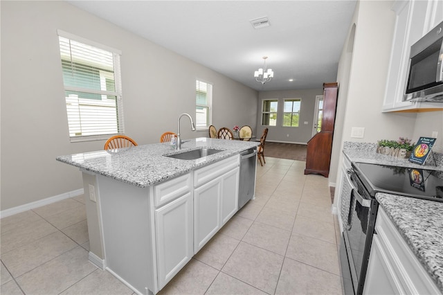 kitchen with white cabinetry, sink, a kitchen island with sink, and stainless steel appliances