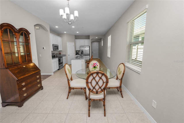 tiled dining space featuring a notable chandelier