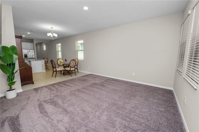 living room with a textured ceiling and light carpet