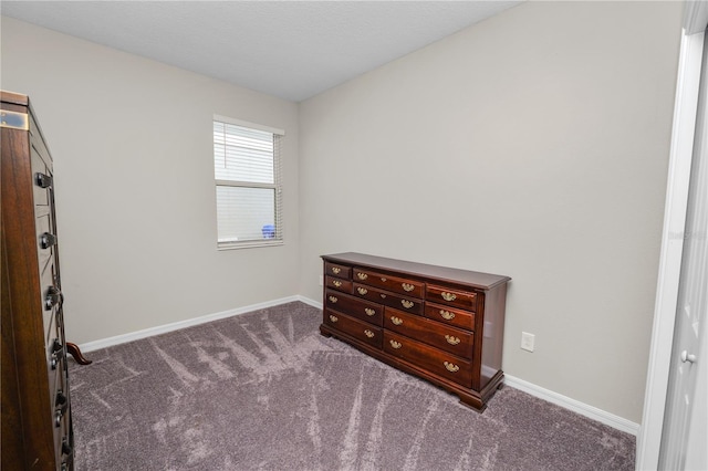 bedroom with dark colored carpet