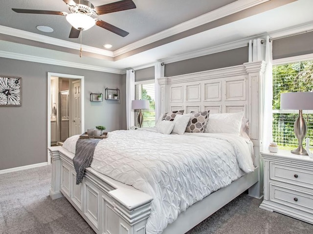 bedroom featuring a tray ceiling, carpet flooring, ceiling fan, and crown molding