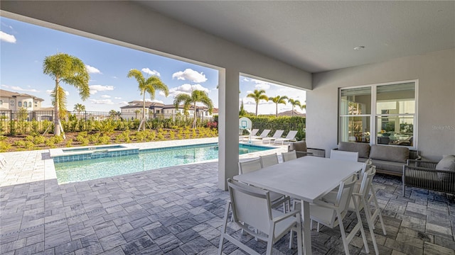 view of swimming pool featuring an in ground hot tub, a patio, and an outdoor hangout area