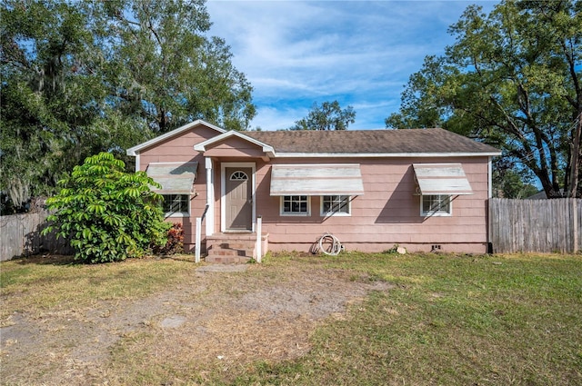 bungalow-style house with a front yard