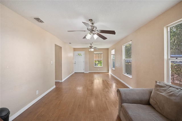 interior space with hardwood / wood-style floors, ceiling fan, and a textured ceiling