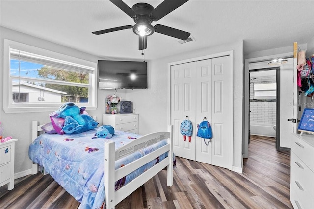 bedroom with ceiling fan, a closet, and dark hardwood / wood-style flooring