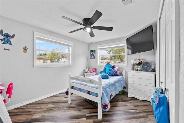 bedroom with ceiling fan and dark hardwood / wood-style flooring