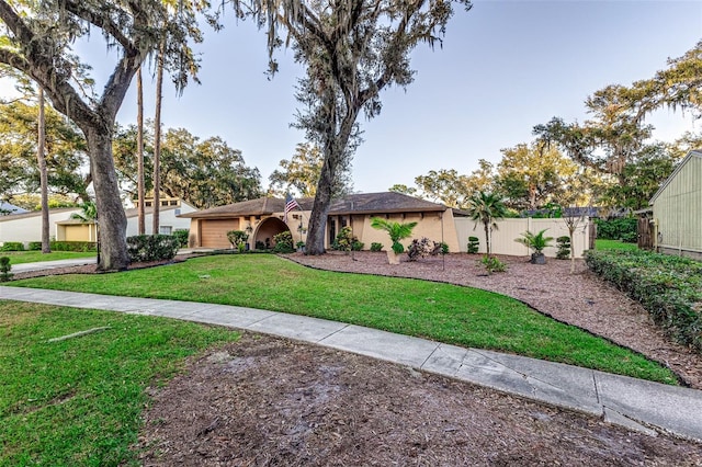 ranch-style home with a front lawn