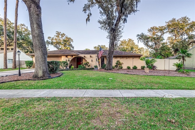 ranch-style home featuring a front lawn