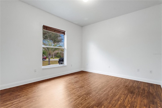 spare room featuring wood-type flooring