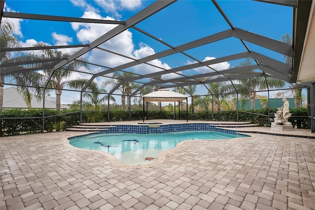 view of pool featuring an in ground hot tub, a lanai, and a patio