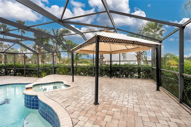 view of pool with an in ground hot tub, a lanai, and a patio area