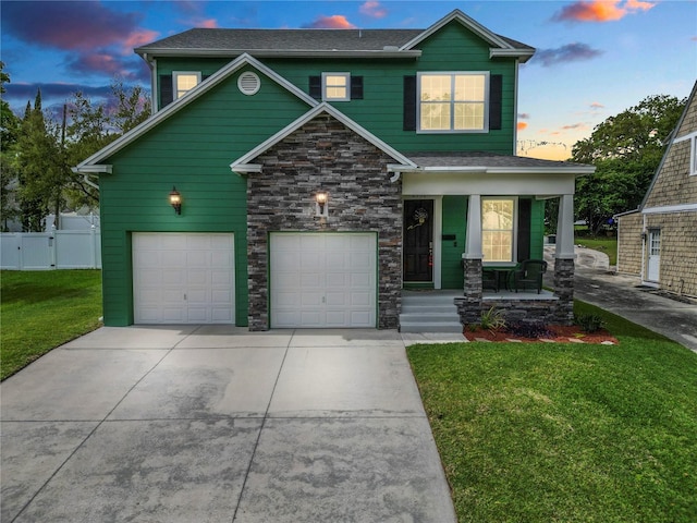 craftsman inspired home featuring a lawn, covered porch, and a garage