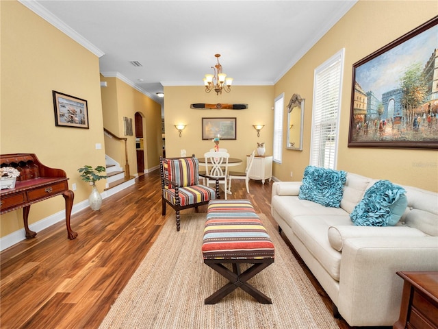 living room featuring hardwood / wood-style floors, a notable chandelier, and ornamental molding