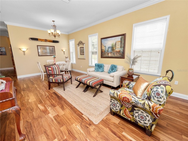 living room with an inviting chandelier, light hardwood / wood-style flooring, and ornamental molding