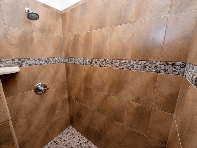 bathroom with a tile shower