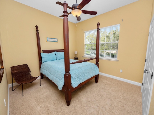 bedroom with ceiling fan and light carpet