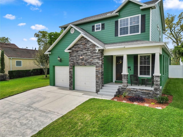 craftsman-style home featuring a front lawn, a garage, and covered porch