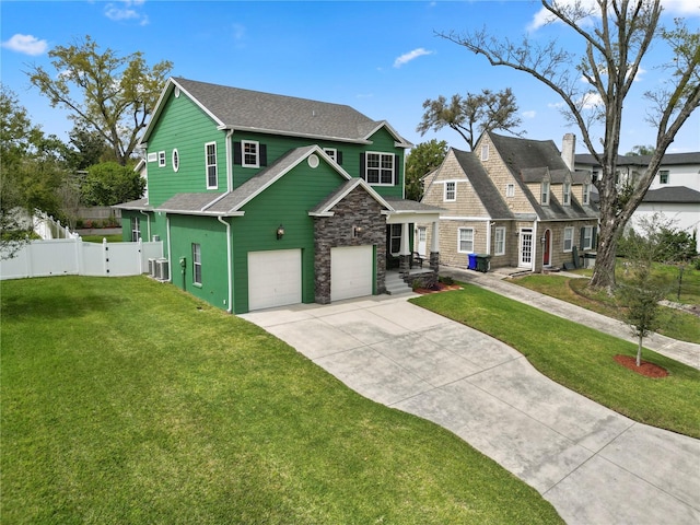 view of front of property with a garage, central AC, and a front yard