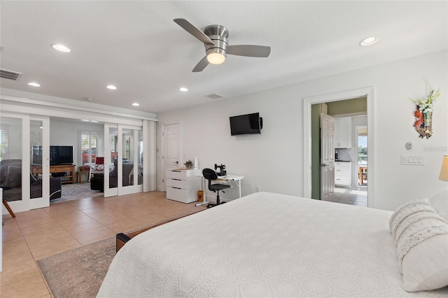 tiled bedroom with ceiling fan and french doors