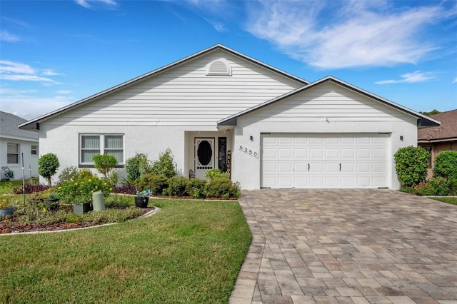 ranch-style home with a front yard and a garage