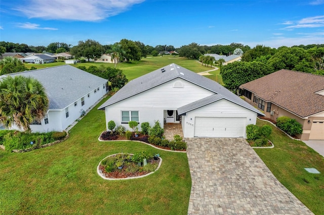 view of front of house with a front yard and a garage