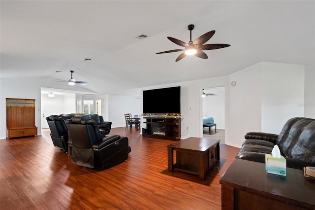 living room featuring hardwood / wood-style flooring and vaulted ceiling