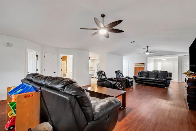 living room featuring ceiling fan and dark wood-type flooring