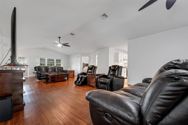 living room featuring hardwood / wood-style flooring, ceiling fan, and vaulted ceiling