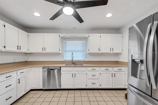 kitchen featuring white cabinets, light tile patterned floors, sink, and appliances with stainless steel finishes